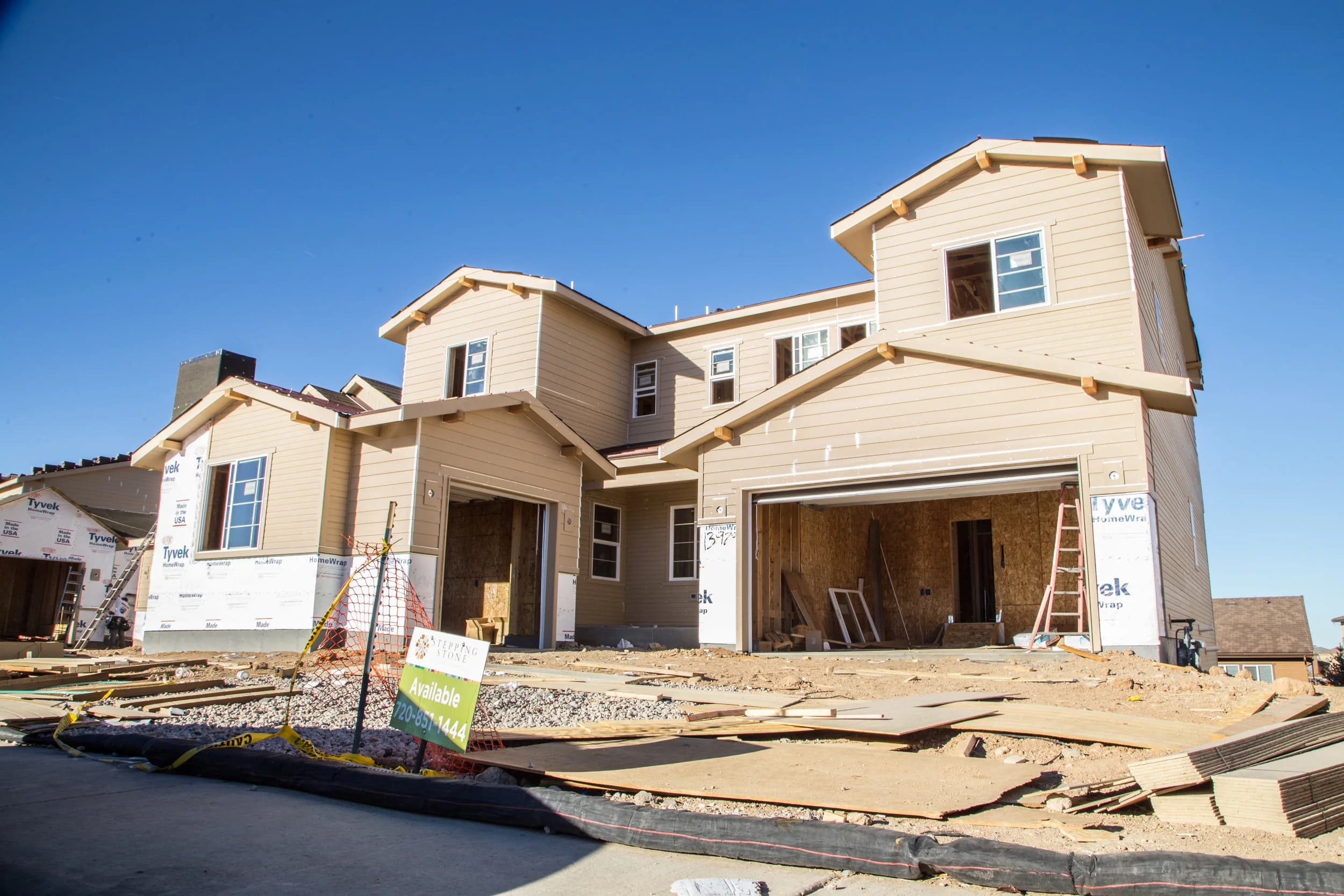 Rows of new single-family homes under framing