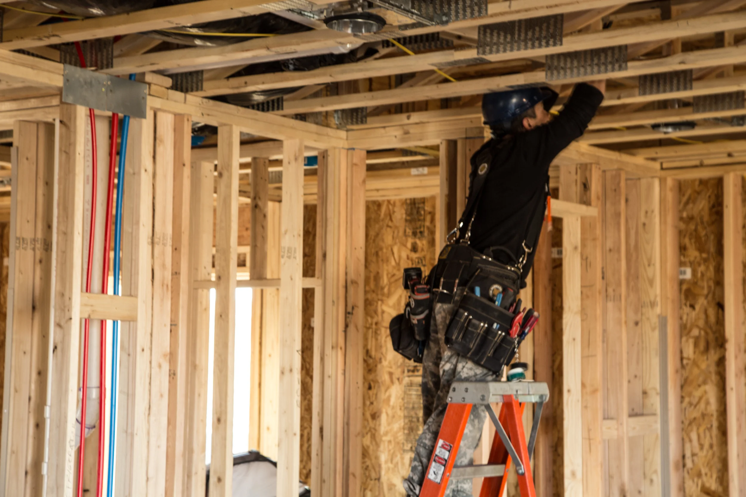 Electrician wiring a new single-family home