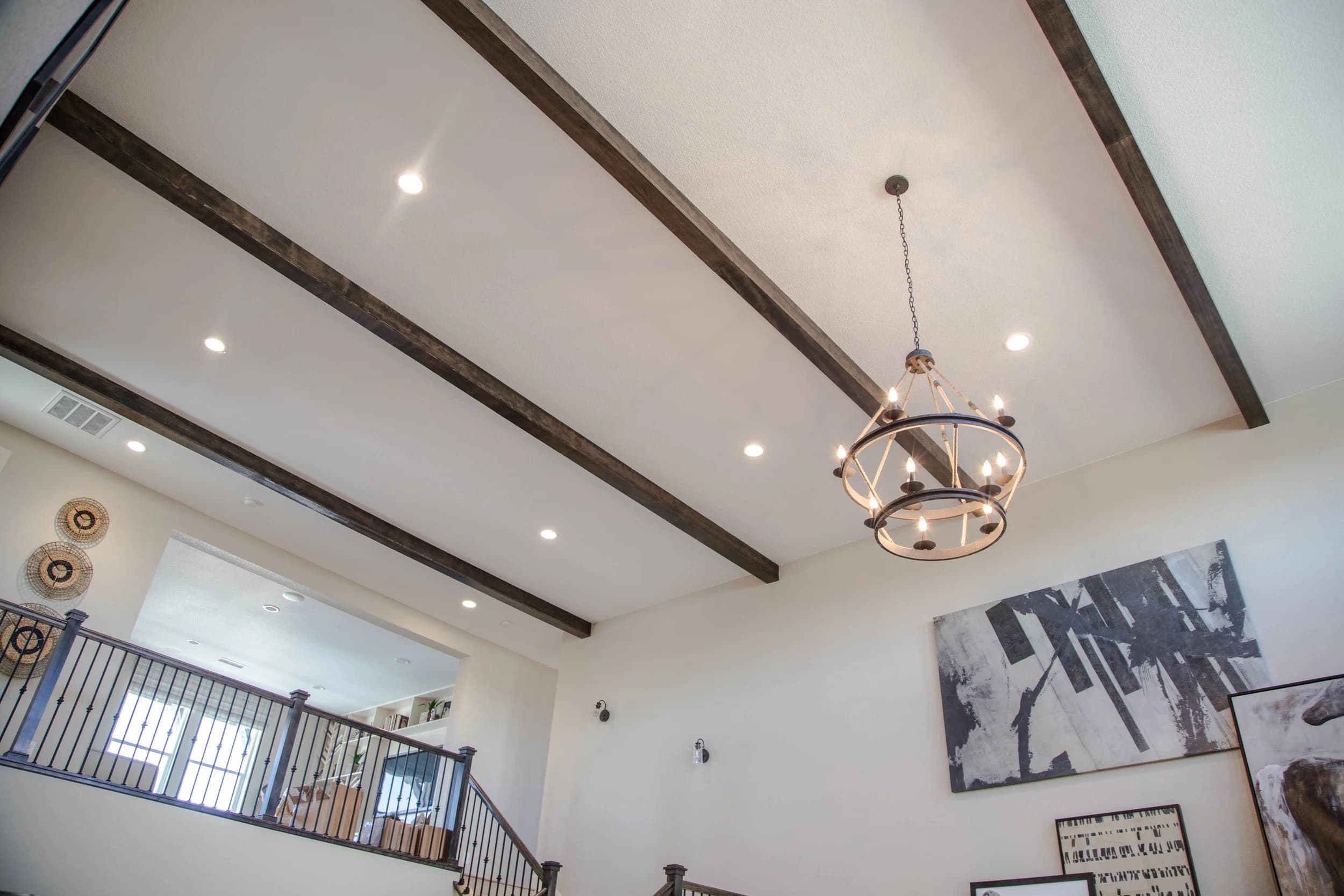 Interior with beam ceiling and chandelier lighting in a new home