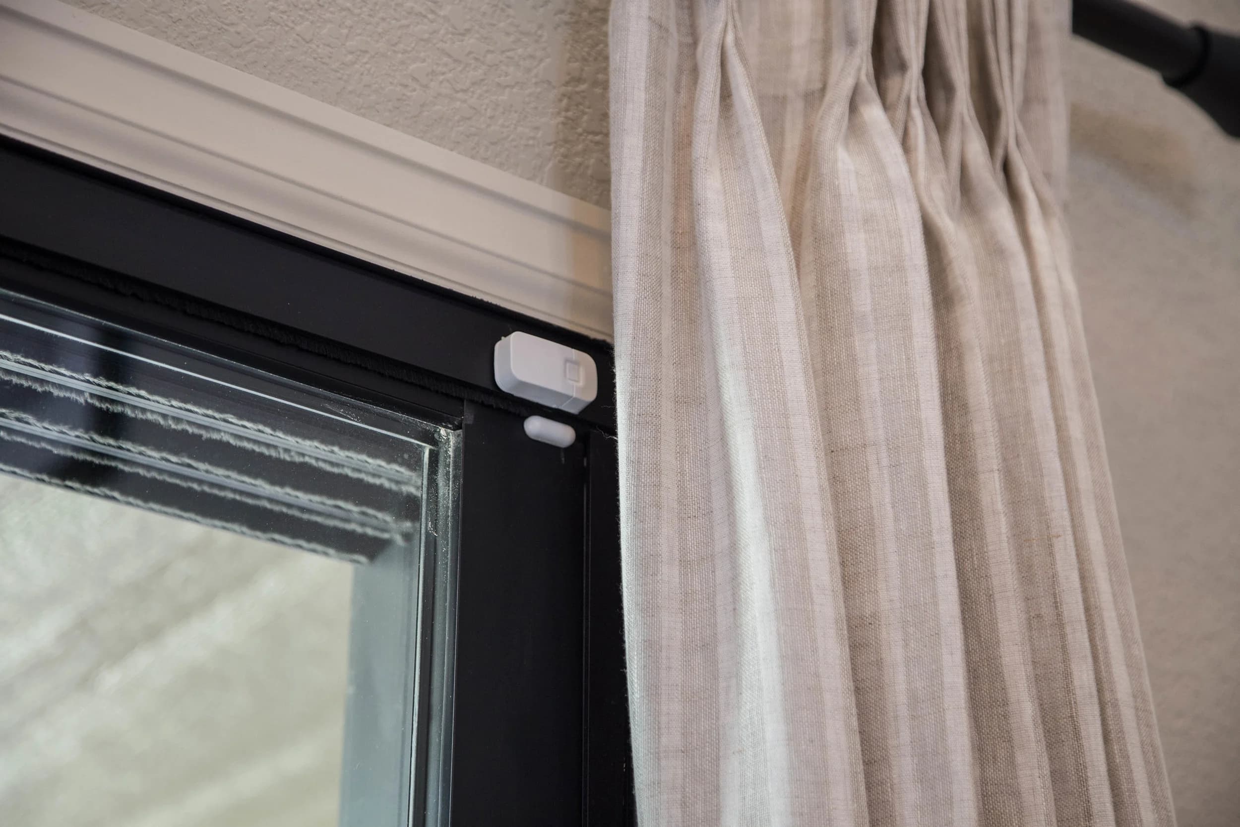 Low-voltage contact sensor installed at a window