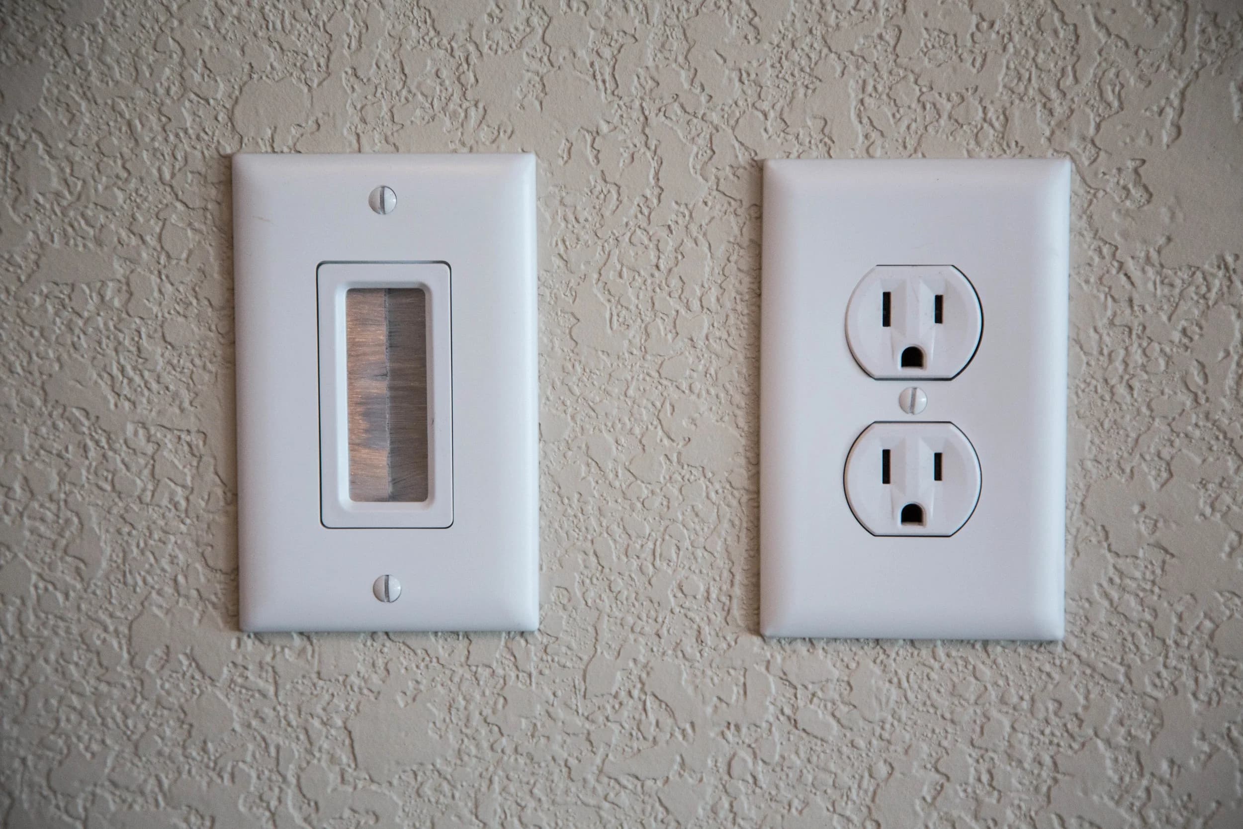Dimmer switch and outlet installed on a wall
