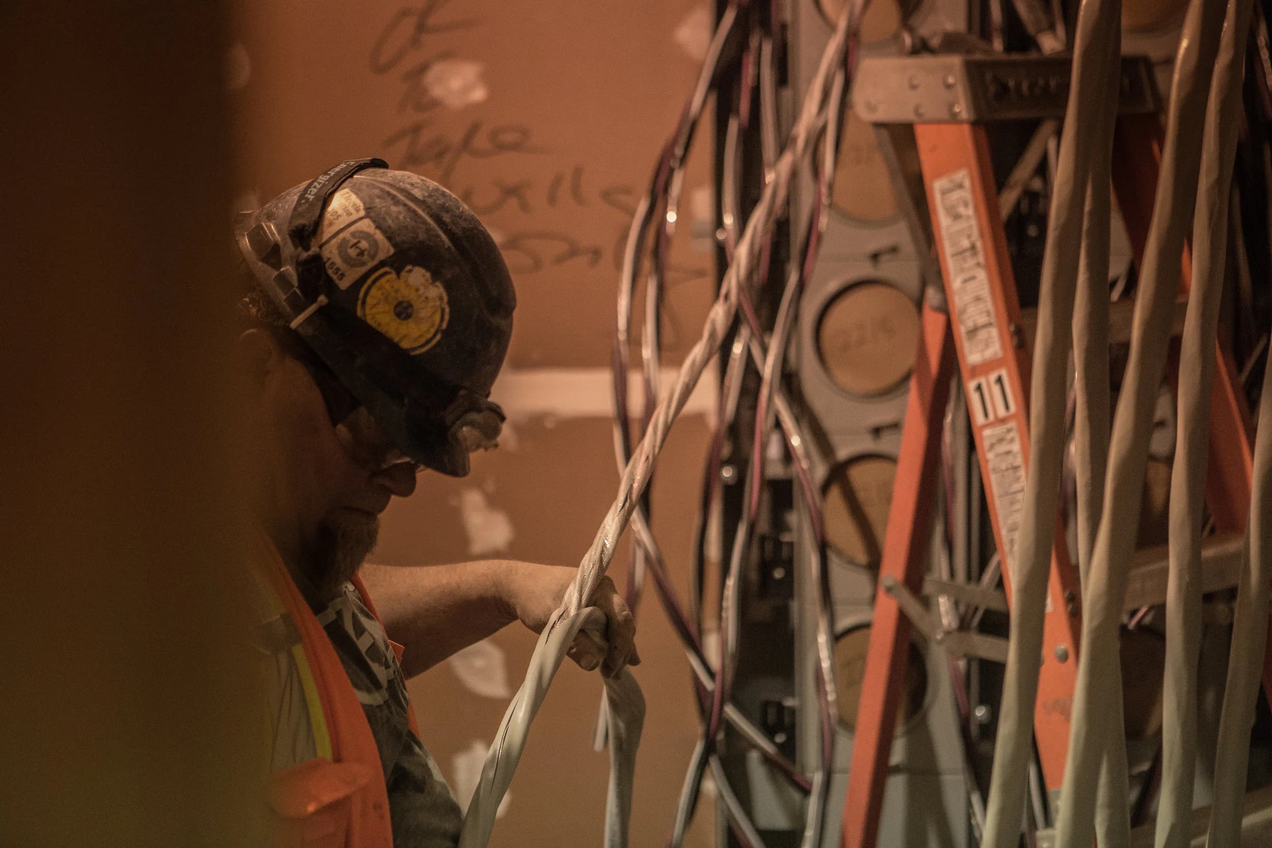 A Courtesy Electric electrician pulling wire on a jobsite